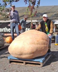 Joel Holland (above) accepting his award for the largest pumpkin tipping the scales at 1450.5 pounds, with Lee Roof (left), at the Fourth Annual Skagit Valley Giant Pumpkin Festival at Christianson’s Nursery in Mount Vernon. COURTESY PHOTO